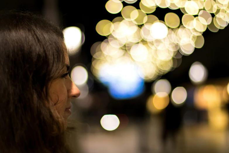 a woman looking up while standing on a city street