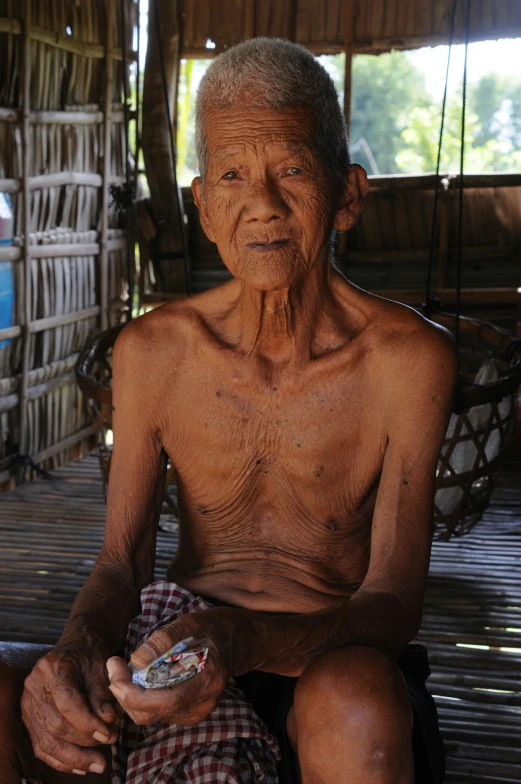 a man holding a bottle and a toothbrush