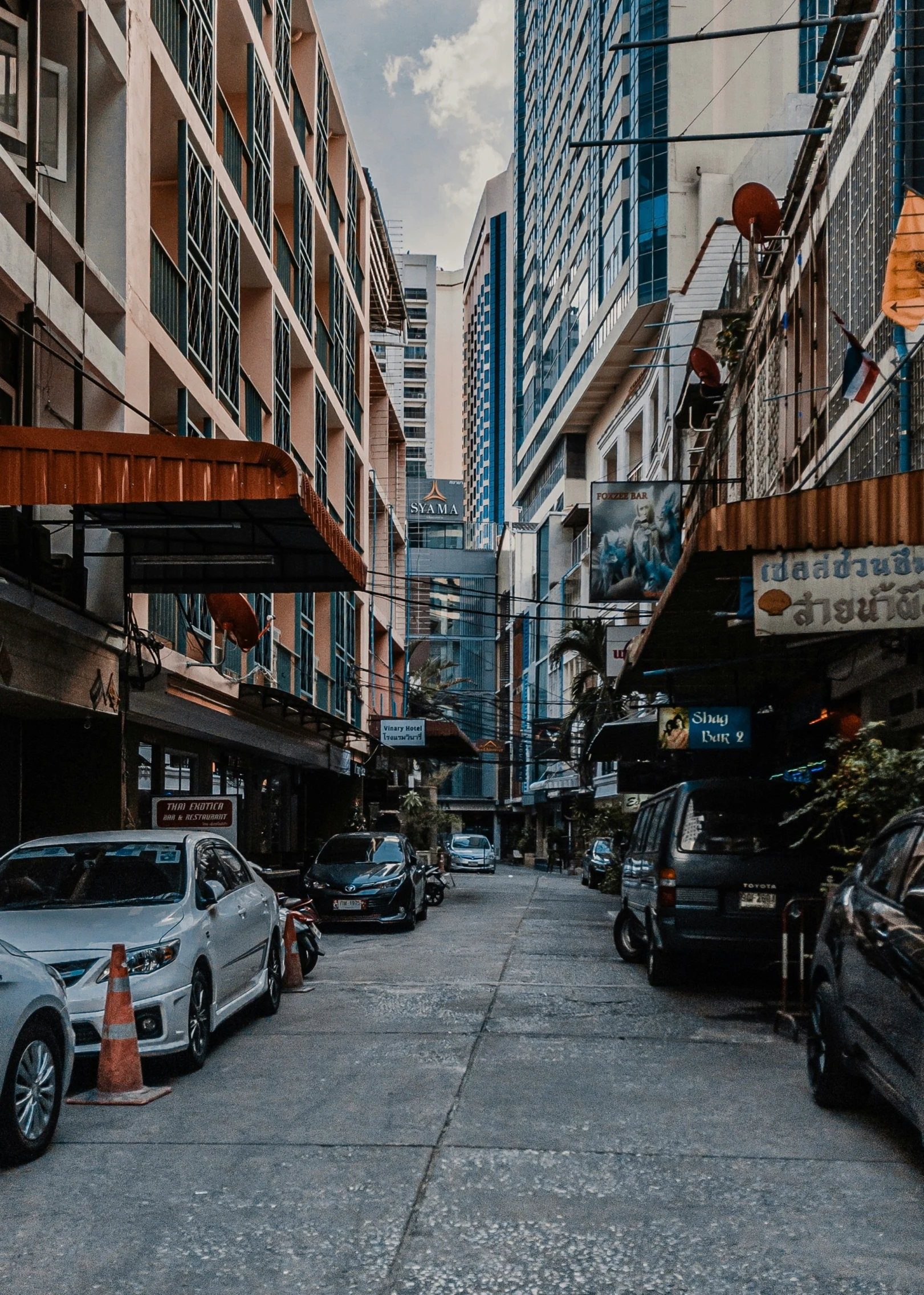 a city street filled with cars and tall buildings