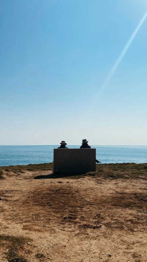 two small huts are sitting out by the ocean