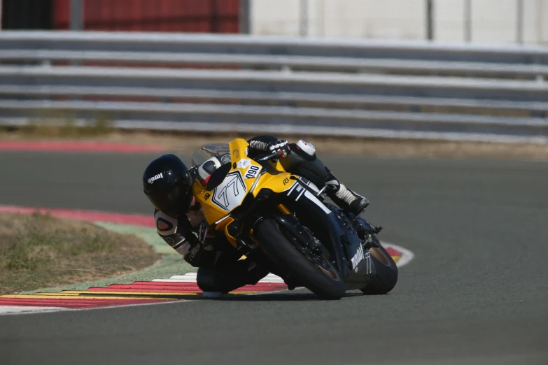 a person riding a motorcycle on a race track