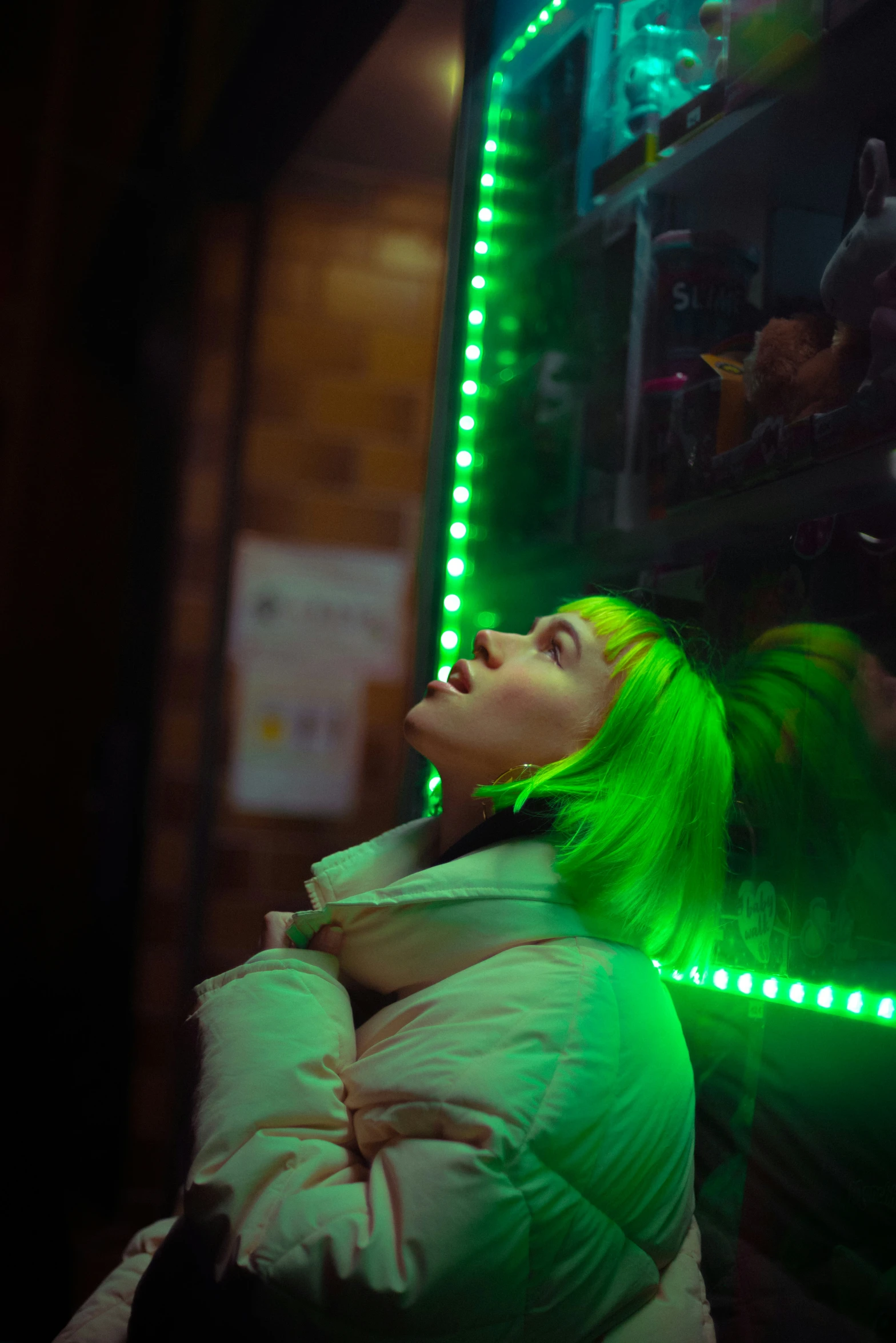 a woman looking up at soing while wearing lights in front of her