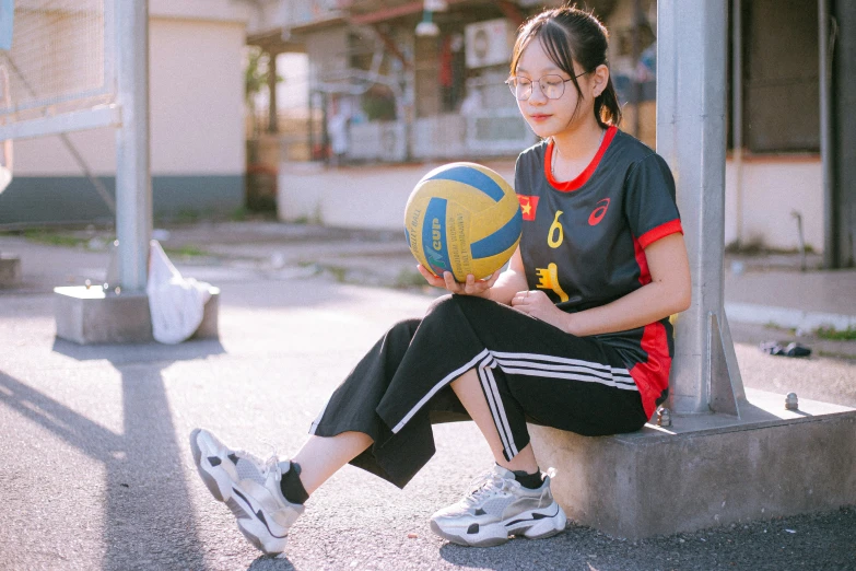 a  with glasses holding a basketball ball