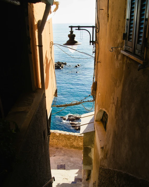 a narrow road with some buildings near the water