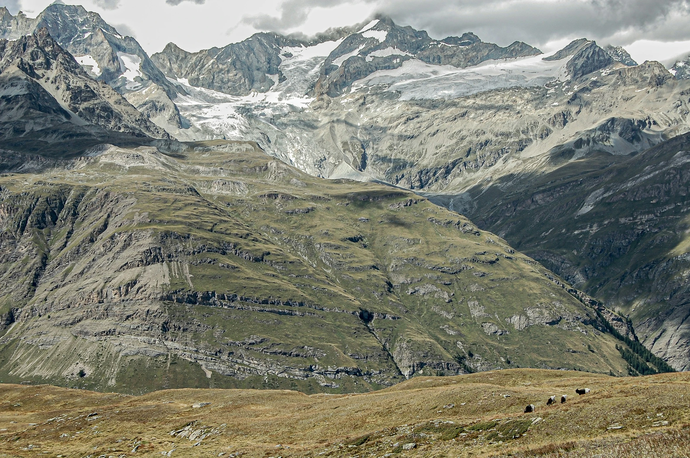 a mountain with snow capped mountains in the distance