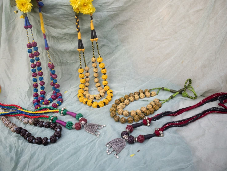 a collection of necklaces that include flower decorations and beads