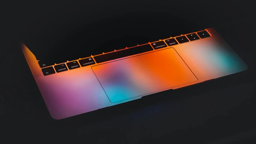 a colorful apple laptop with a dark background