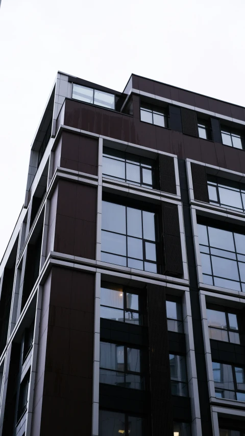 a tall brown building with many windows and balconies