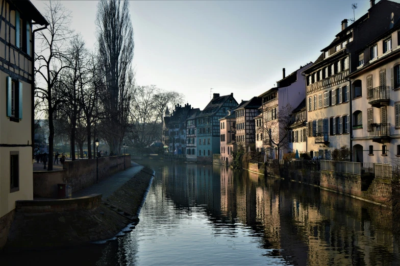 a city canal running between several old, residential buildings