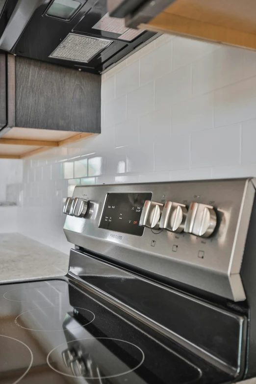 the kitchen has a large range with black and silver appliances