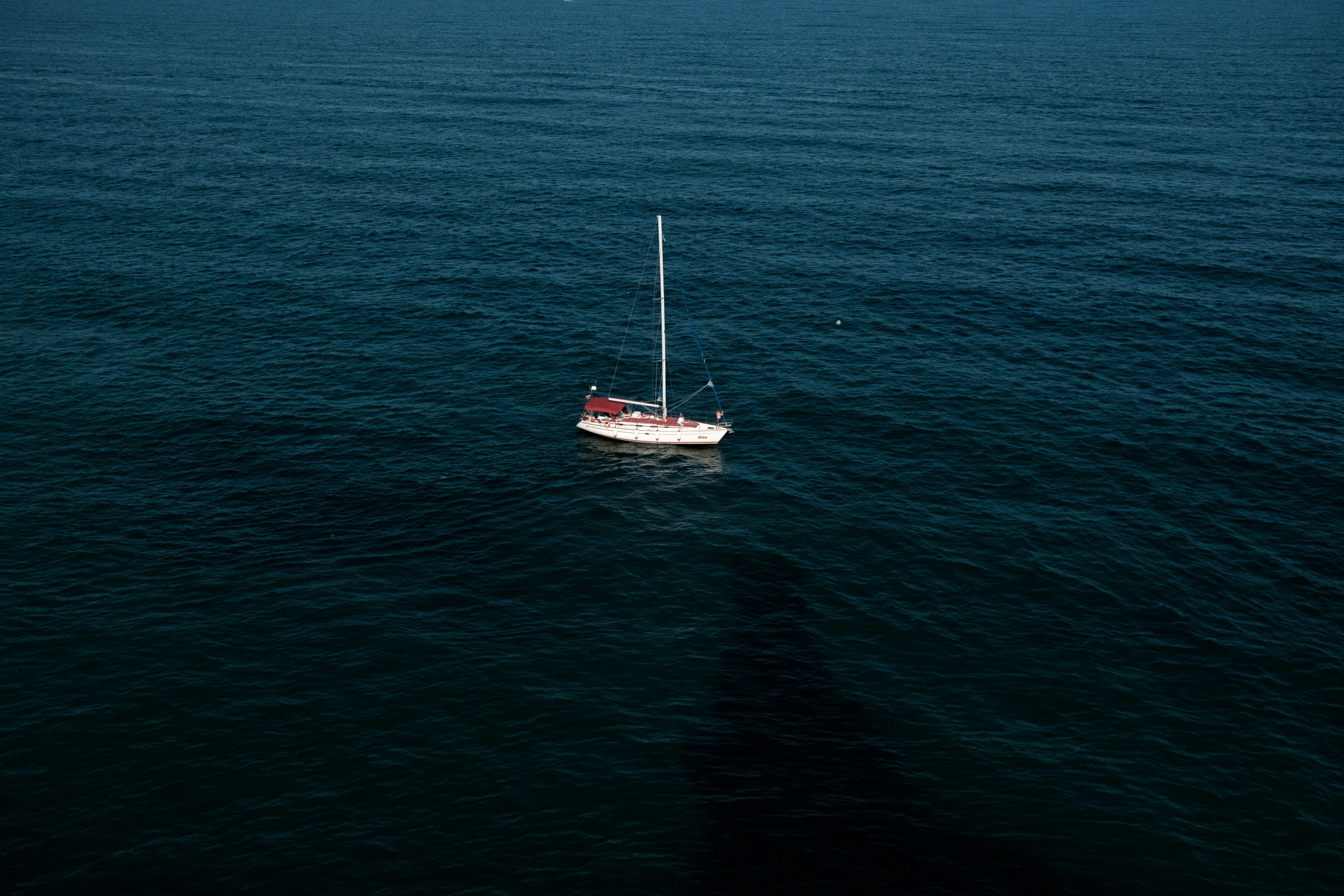 a boat is shown sailing in the middle of the water