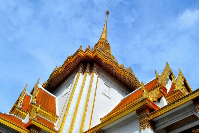 a large tower with golden accents in front of the sky