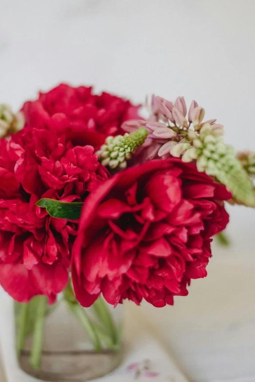 a vase full of pretty flowers sitting on top of a table