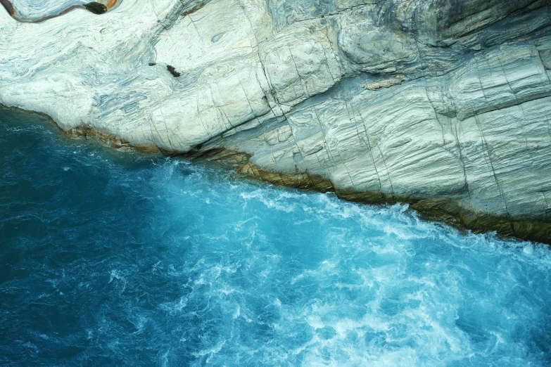 a picture from above of the water and a rocky cliff