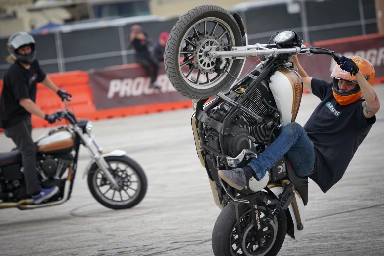 a person on a motorcycle holding the front wheels