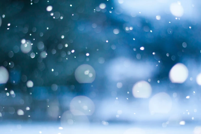 an abstract blurry image of snow falling in the air