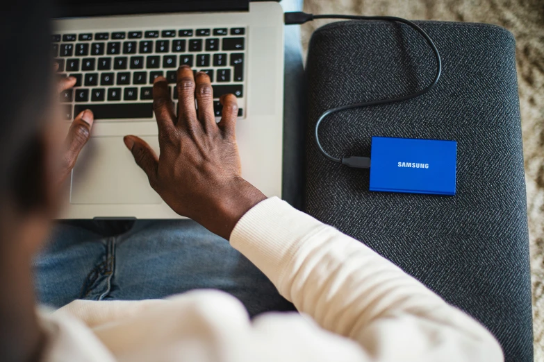 a woman using her laptop computer on a couch