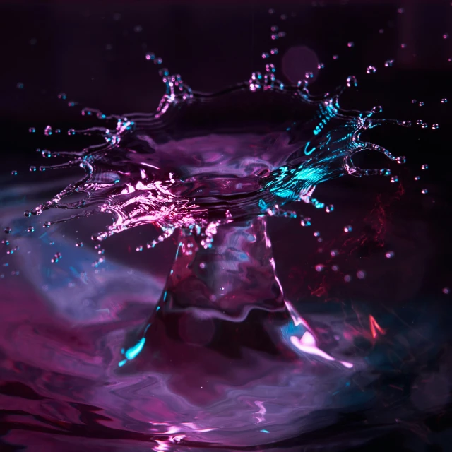 a purple and blue substance is falling into water