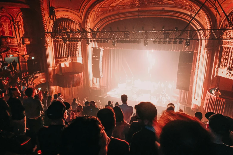 a large crowd of people are sitting and watching a concert