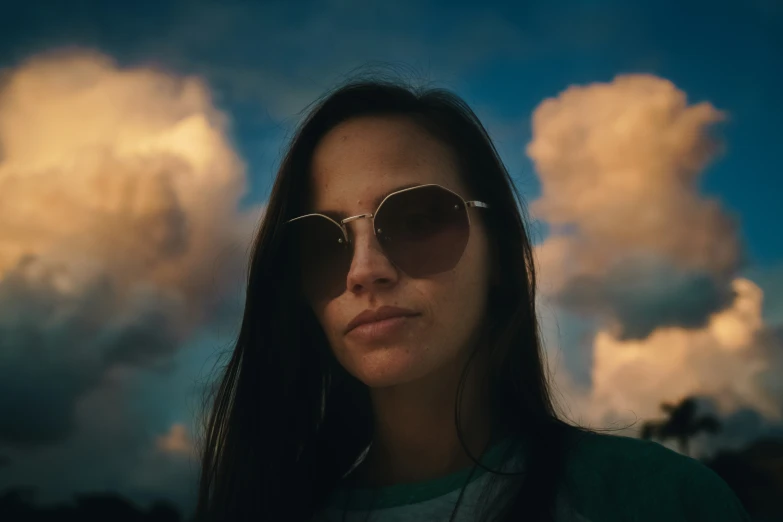 a woman in a green shirt and sunglasses