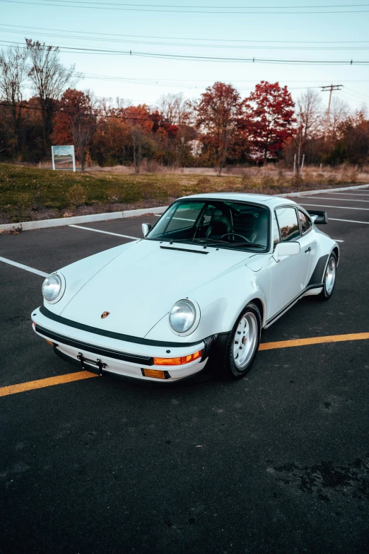 a white car is parked in a parking lot