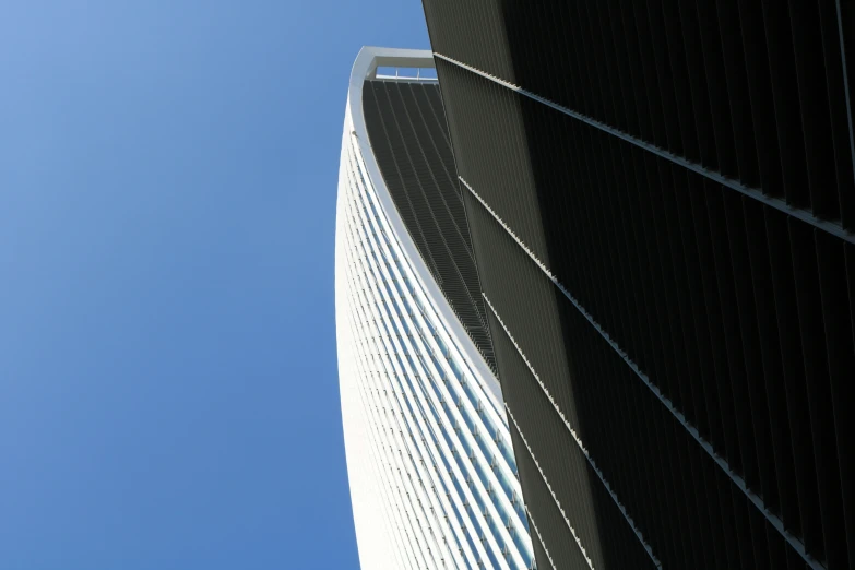 a tall white building with windows below it