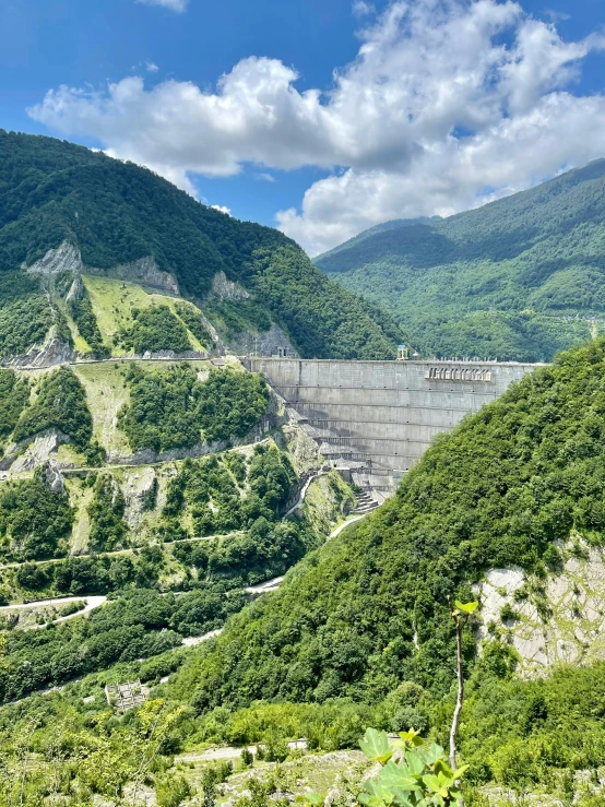 a large dam is in the middle of a mountain