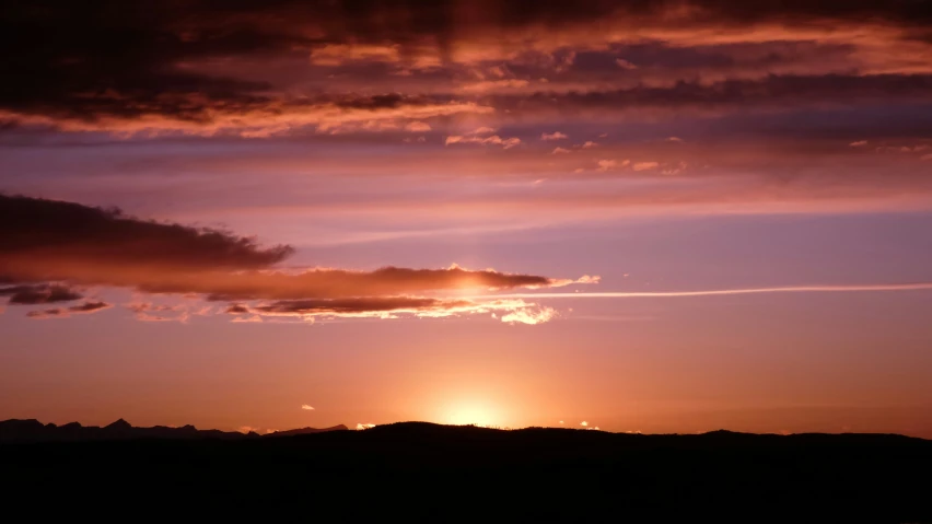 the sun is setting over a very pretty landscape