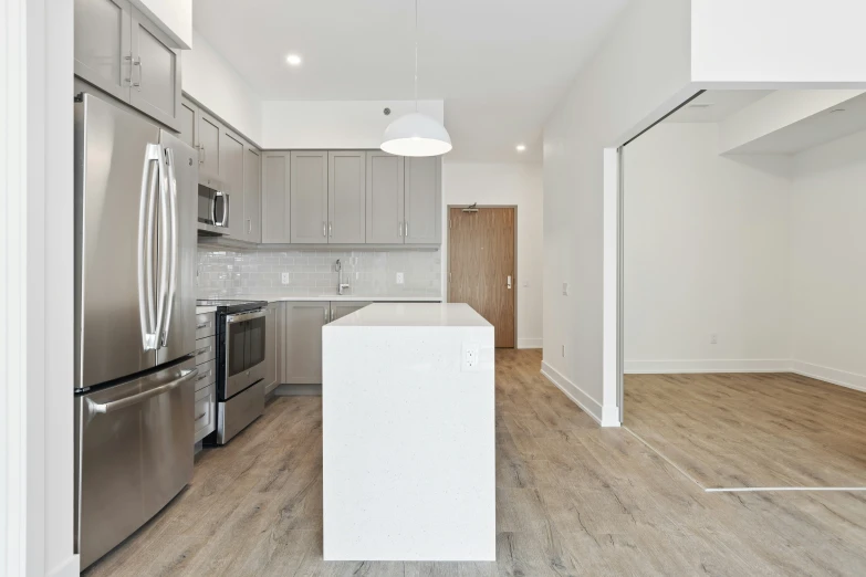 a kitchen with stainless steel refrigerator, silver appliances, and a breakfast bar