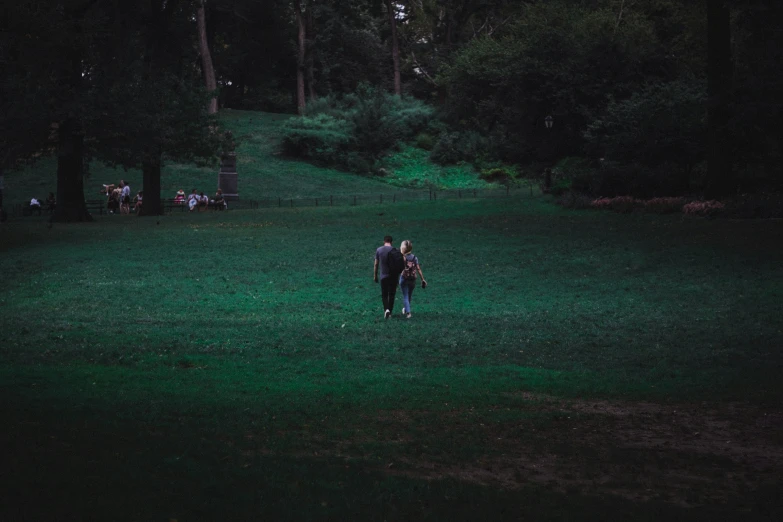 a person walks in the dark with some umbrellas