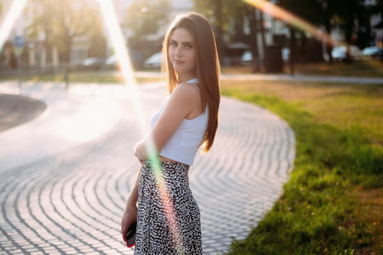 a girl posing on a sunny day with her hand on her hips