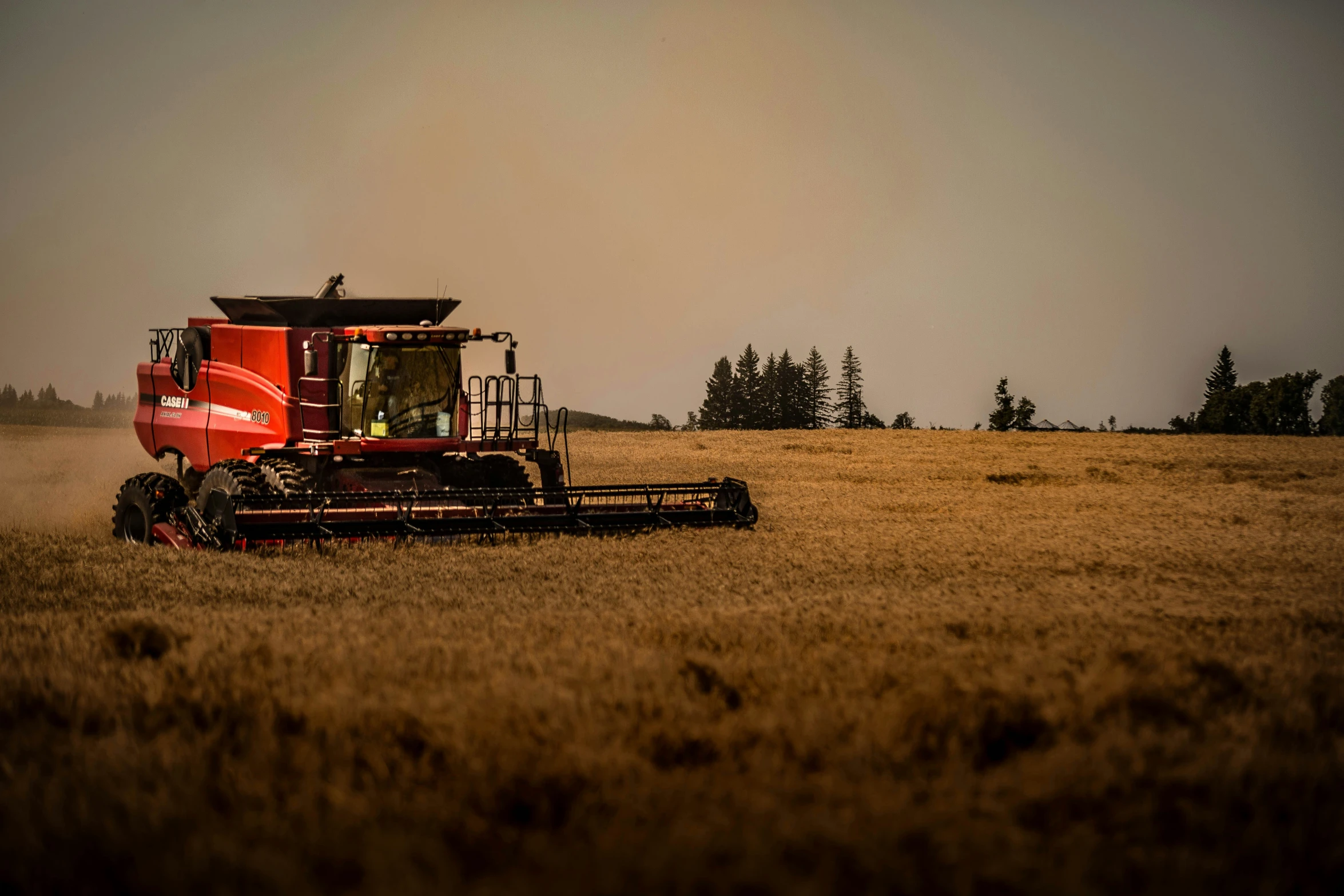 an image of a red tractor in the field