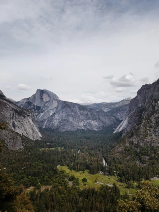 the mountain and valley are located among the trees