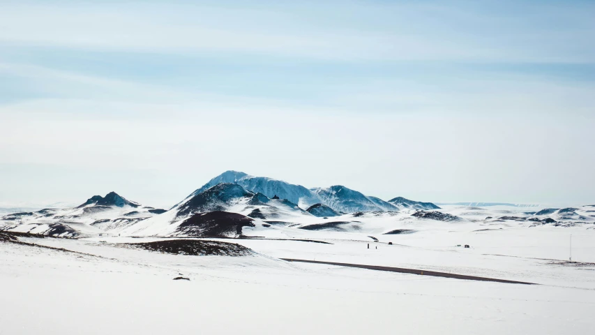 a mountain range on a snowy day covered with snow