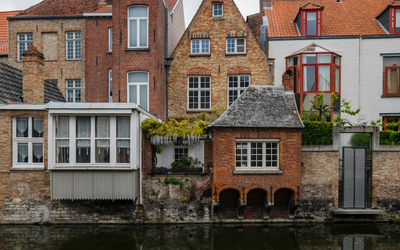 brick homes lining a river in an old city