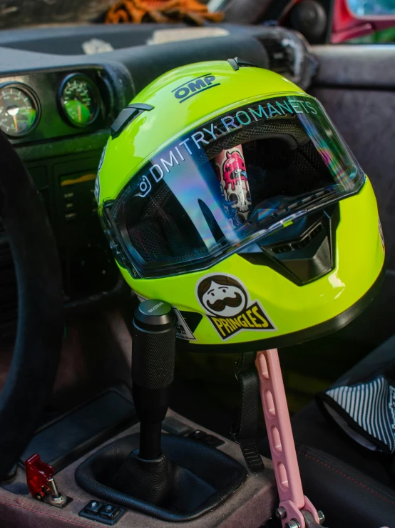 a yellow helmet on a car radio and dashboard