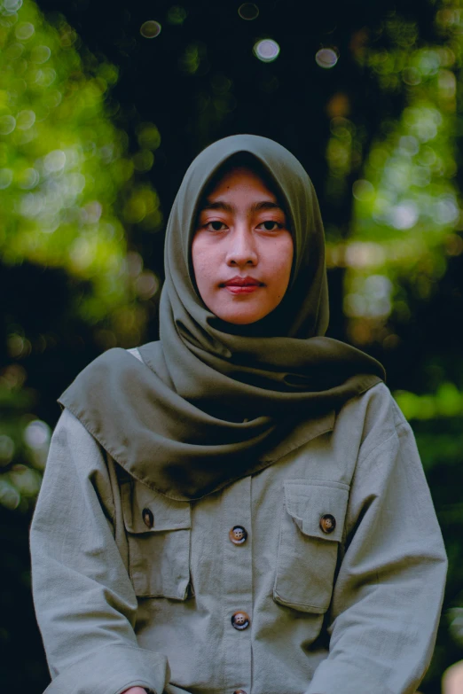 young asian woman in a coat sitting outside