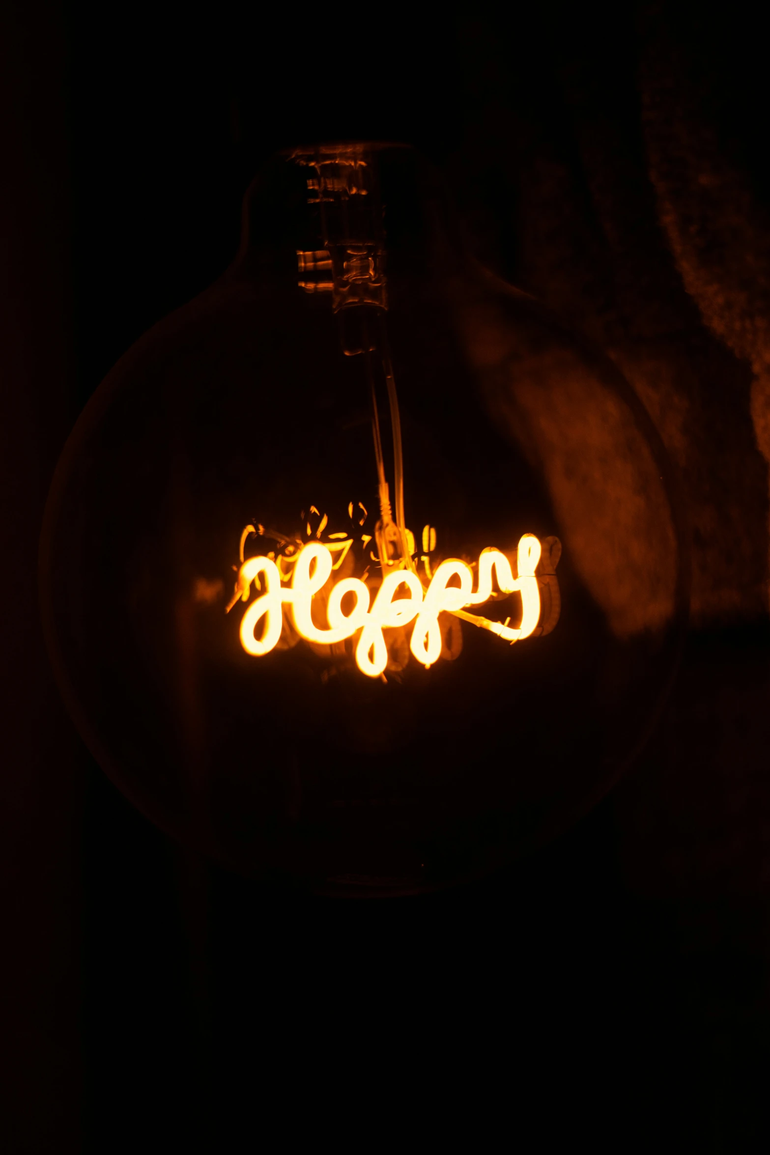 a lighted bottle with the word boozy in it