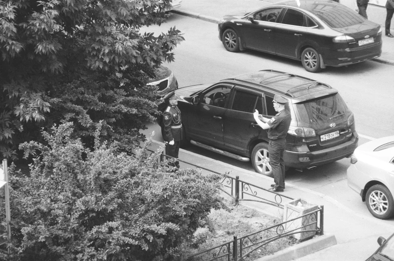 black and white pograph of two men in traffic