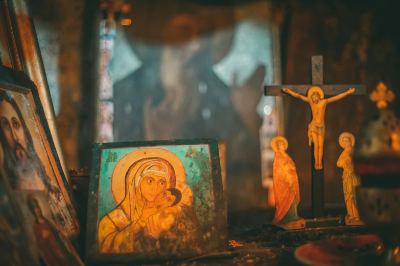 a bunch of religious items are sitting on a shelf