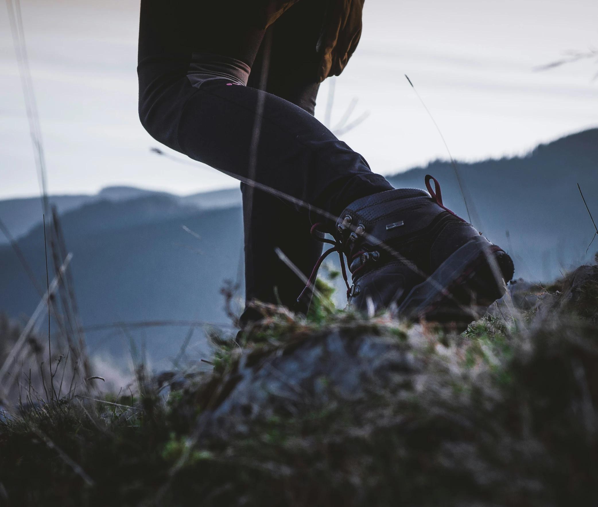 the legs of a person riding their bike on a mountain slope