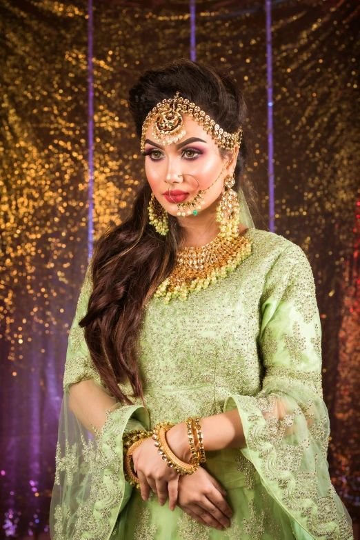 indian bride in green posing for the camera