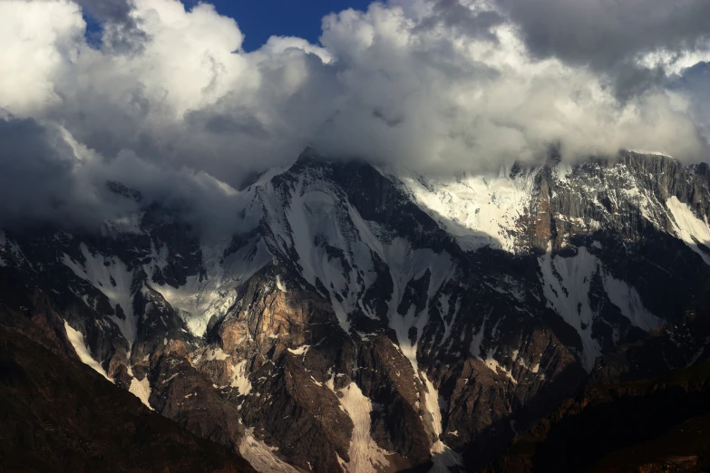 a very tall mountain with some clouds in it