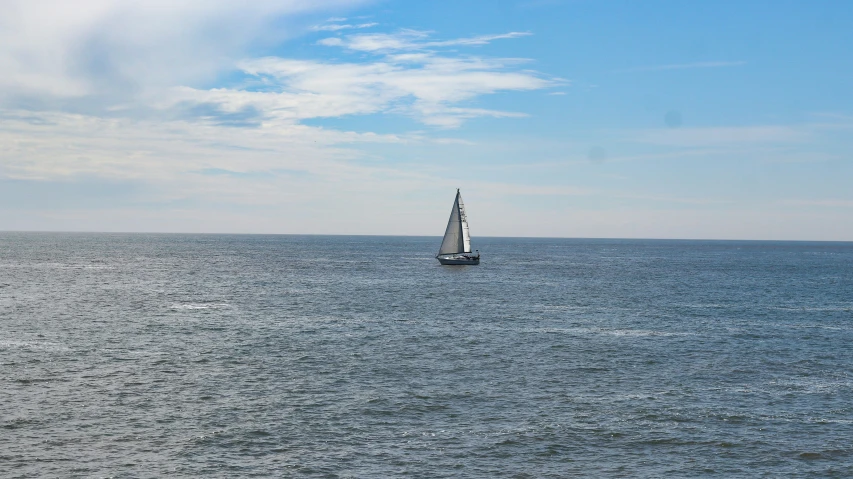 a sail boat with the sails down is on the water