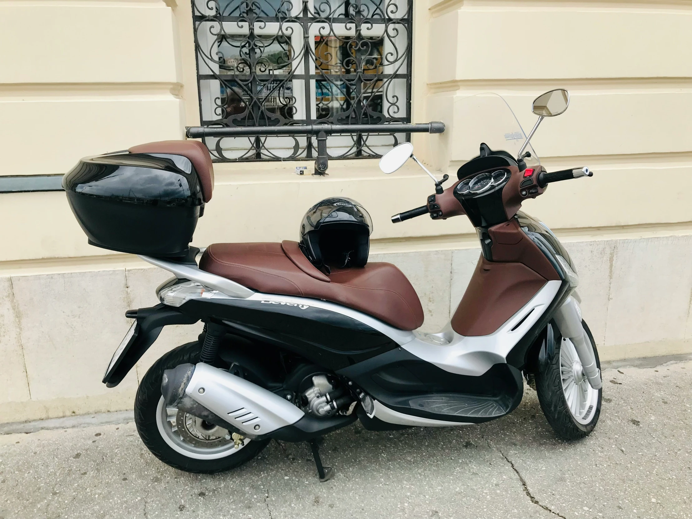 a moped with a saddle bag on the back