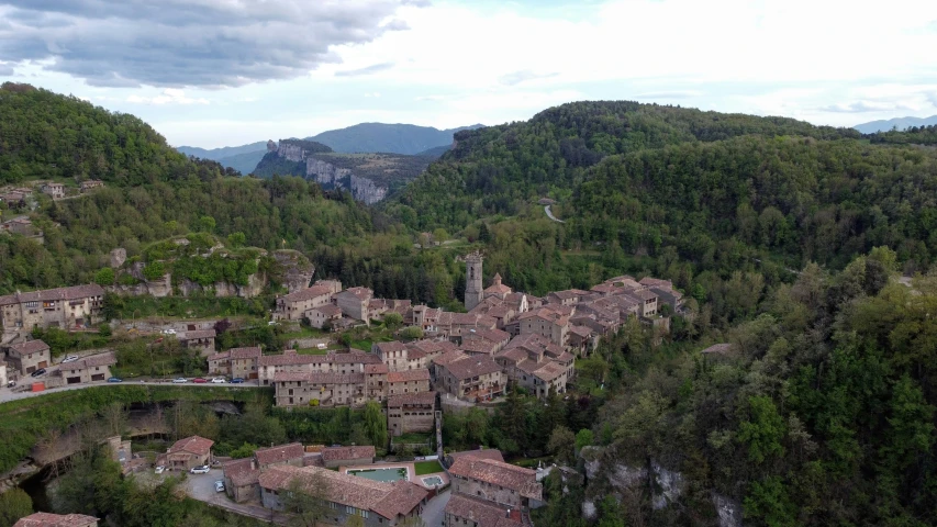 a large, old village with mountains and trees