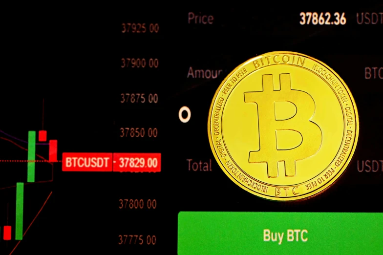 a bitcoin on a dark background with several candles