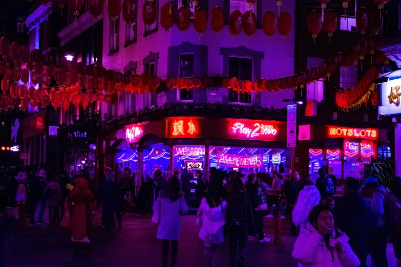 a street market with several neon signs and decorations