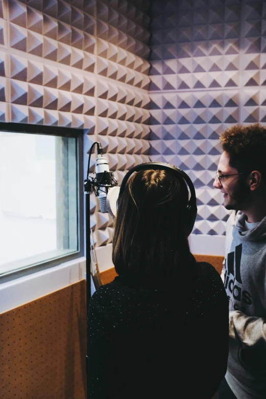 a man is recording another person with headphones