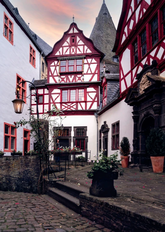 a bricked courtyard with stairs and trees